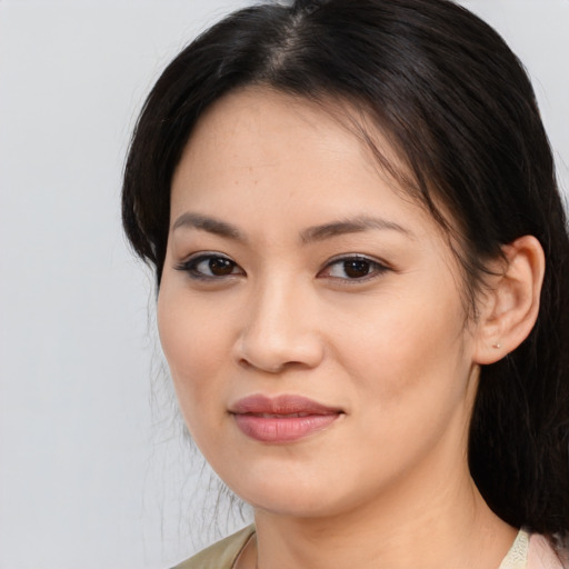 Joyful asian young-adult female with medium  brown hair and brown eyes