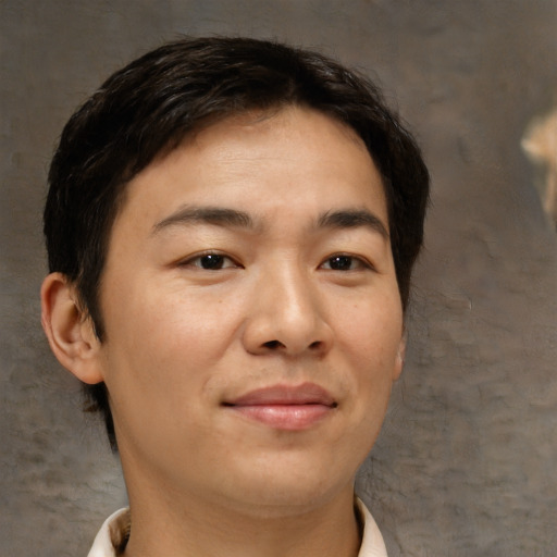 Joyful asian adult male with short  brown hair and brown eyes
