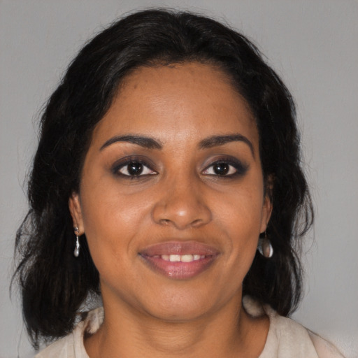 Joyful black adult female with medium  black hair and brown eyes