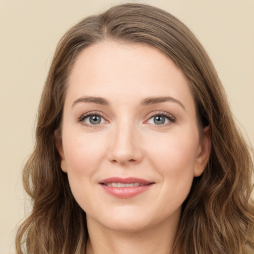 Joyful white young-adult female with long  brown hair and grey eyes