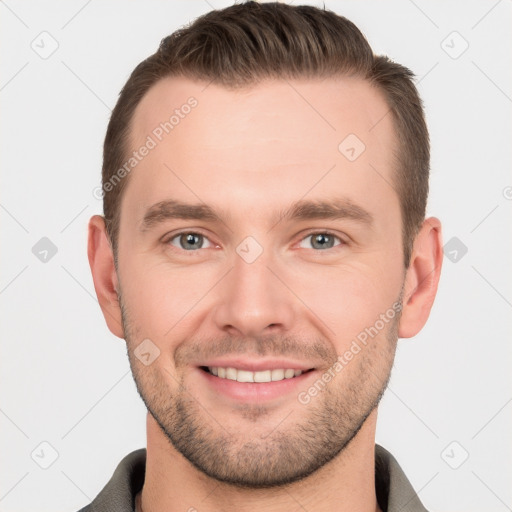 Joyful white young-adult male with short  brown hair and grey eyes