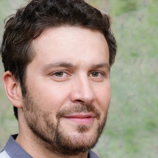 Joyful white adult male with short  brown hair and grey eyes