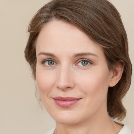 Joyful white young-adult female with medium  brown hair and green eyes