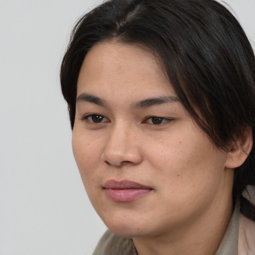 Joyful asian young-adult female with long  brown hair and brown eyes