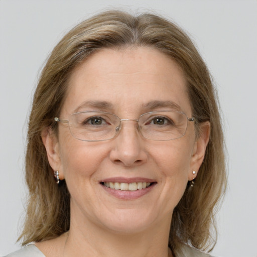 Joyful white adult female with medium  brown hair and brown eyes