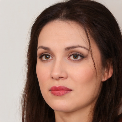 Joyful white young-adult female with long  brown hair and brown eyes