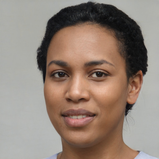 Joyful latino young-adult female with short  black hair and brown eyes