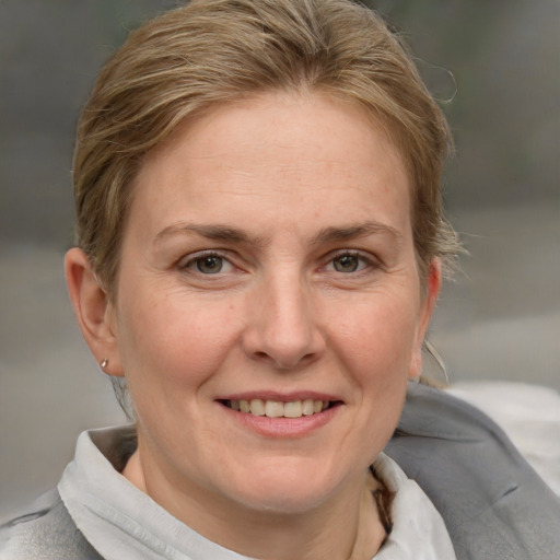 Joyful white adult female with medium  brown hair and blue eyes