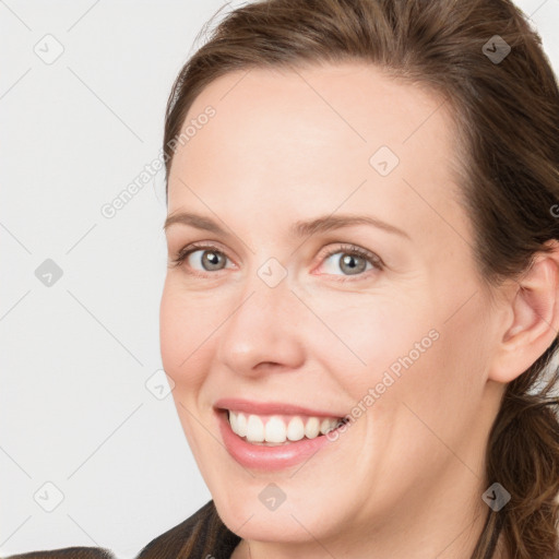 Joyful white young-adult female with long  brown hair and blue eyes