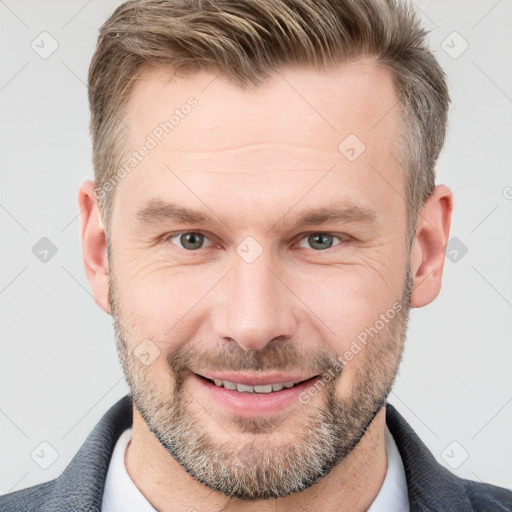 Joyful white adult male with short  brown hair and grey eyes