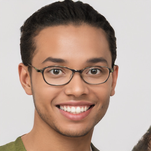 Joyful latino young-adult male with short  brown hair and brown eyes