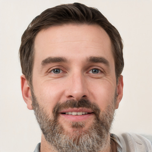 Joyful white adult male with short  brown hair and grey eyes