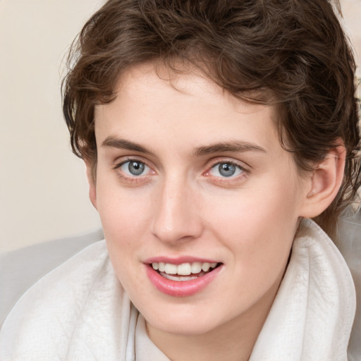 Joyful white young-adult female with medium  brown hair and blue eyes