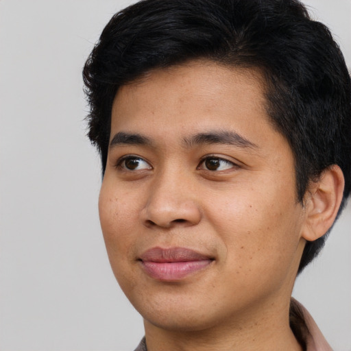 Joyful asian young-adult male with short  brown hair and brown eyes