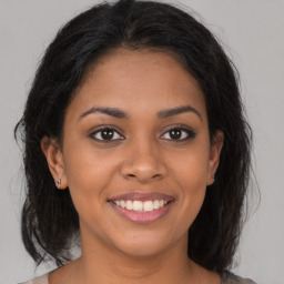 Joyful black young-adult female with medium  brown hair and brown eyes