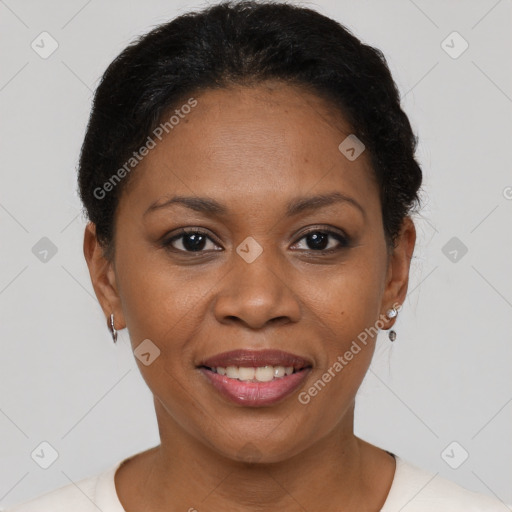 Joyful black adult female with short  brown hair and brown eyes