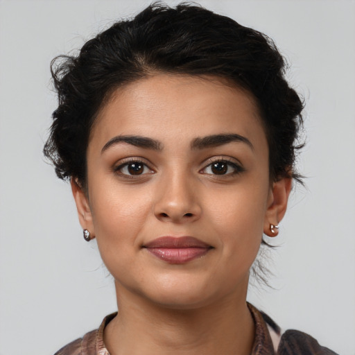 Joyful latino young-adult female with medium  brown hair and brown eyes