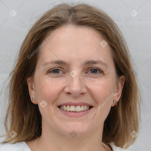 Joyful white adult female with medium  brown hair and grey eyes