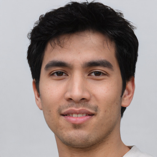 Joyful asian young-adult male with short  black hair and brown eyes