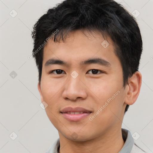 Joyful asian young-adult male with short  brown hair and brown eyes