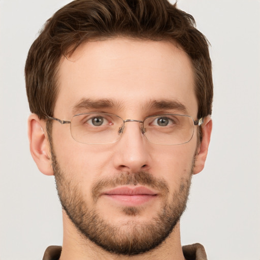 Joyful white young-adult male with short  brown hair and grey eyes