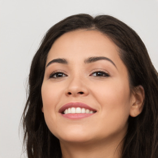 Joyful white young-adult female with long  brown hair and brown eyes