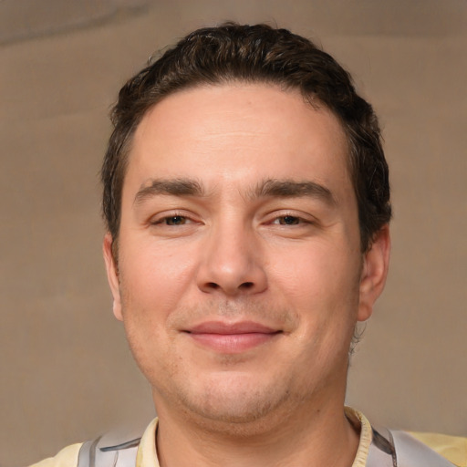 Joyful white adult male with short  brown hair and brown eyes