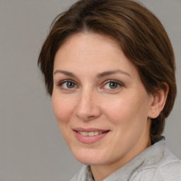 Joyful white adult female with medium  brown hair and brown eyes