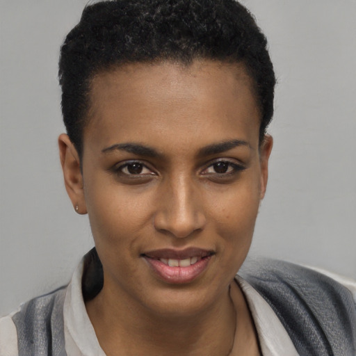 Joyful black young-adult female with short  black hair and brown eyes