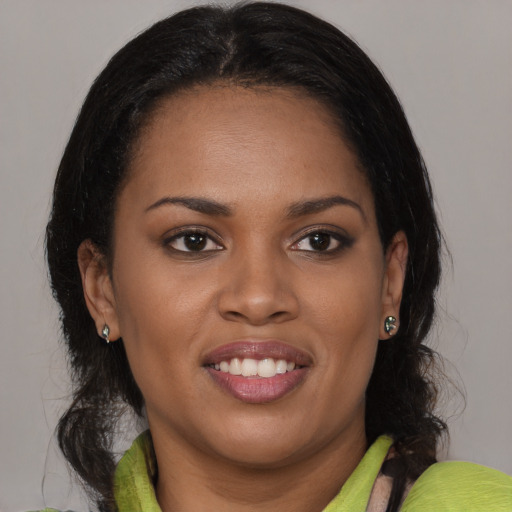 Joyful black young-adult female with medium  brown hair and brown eyes