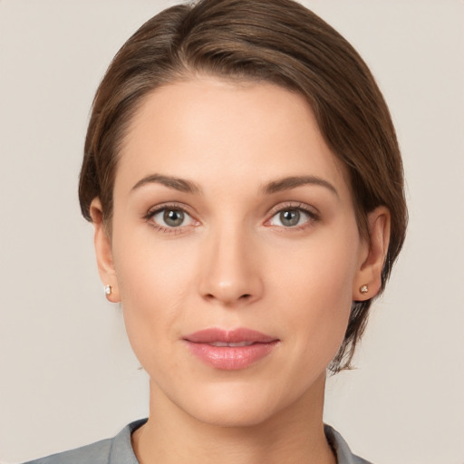 Joyful white young-adult female with short  brown hair and grey eyes