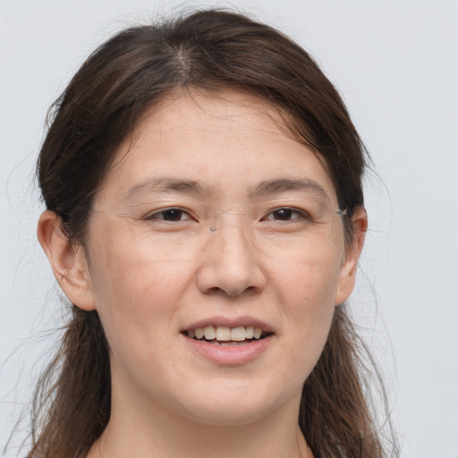 Joyful white adult female with long  brown hair and brown eyes