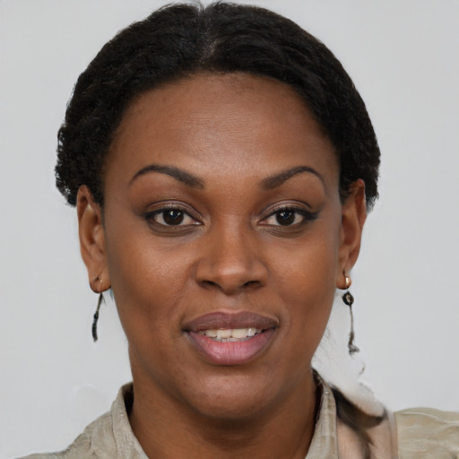 Joyful black adult female with short  brown hair and brown eyes