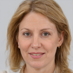 Joyful white adult female with long  brown hair and brown eyes