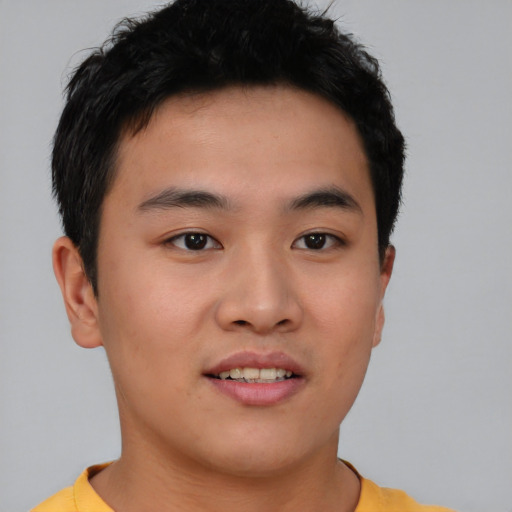 Joyful asian young-adult male with short  brown hair and brown eyes