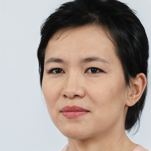 Joyful asian young-adult female with medium  black hair and brown eyes