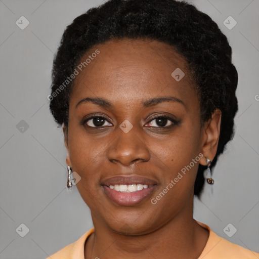 Joyful black young-adult female with short  black hair and brown eyes