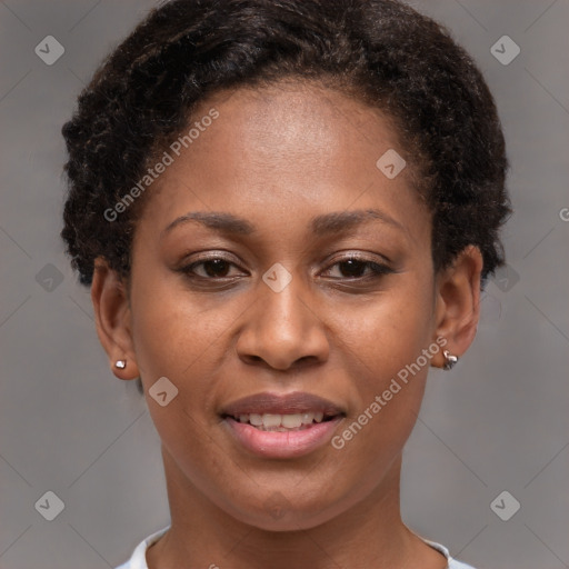 Joyful black young-adult female with short  brown hair and brown eyes