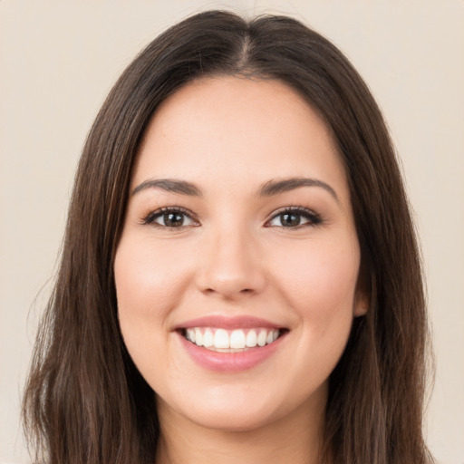 Joyful white young-adult female with long  brown hair and brown eyes