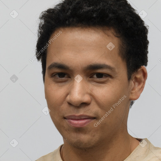 Joyful latino young-adult male with short  brown hair and brown eyes