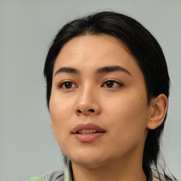 Joyful asian young-adult female with medium  black hair and brown eyes