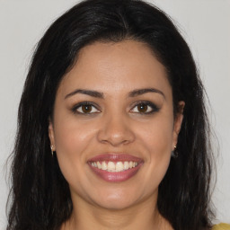 Joyful latino young-adult female with long  brown hair and brown eyes