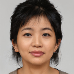 Joyful asian young-adult female with medium  black hair and brown eyes