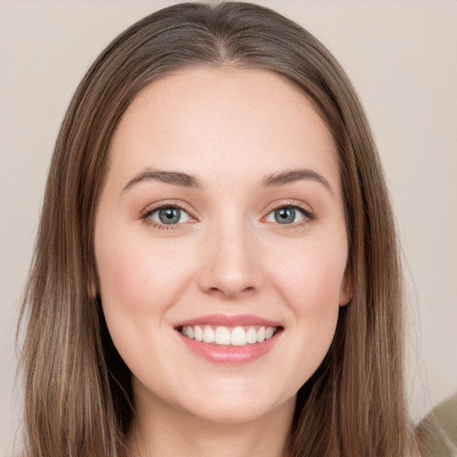 Joyful white young-adult female with long  brown hair and grey eyes