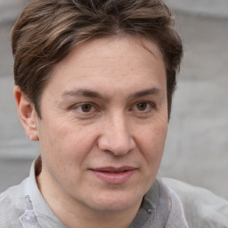 Joyful white adult male with short  brown hair and grey eyes