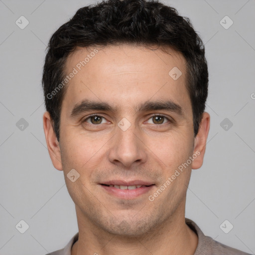 Joyful white young-adult male with short  black hair and brown eyes