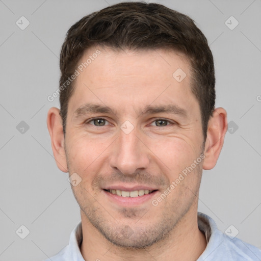 Joyful white adult male with short  brown hair and brown eyes