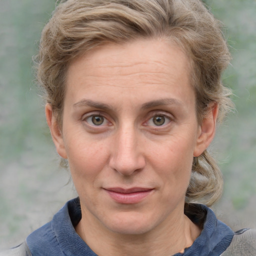 Joyful white adult female with medium  brown hair and blue eyes