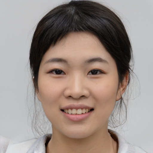 Joyful asian young-adult female with medium  black hair and brown eyes