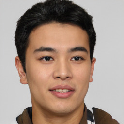 Joyful asian young-adult male with short  brown hair and brown eyes